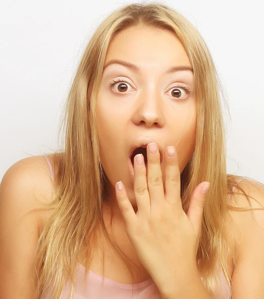 Surprised blond girl holding her head — Stock Photo, Image