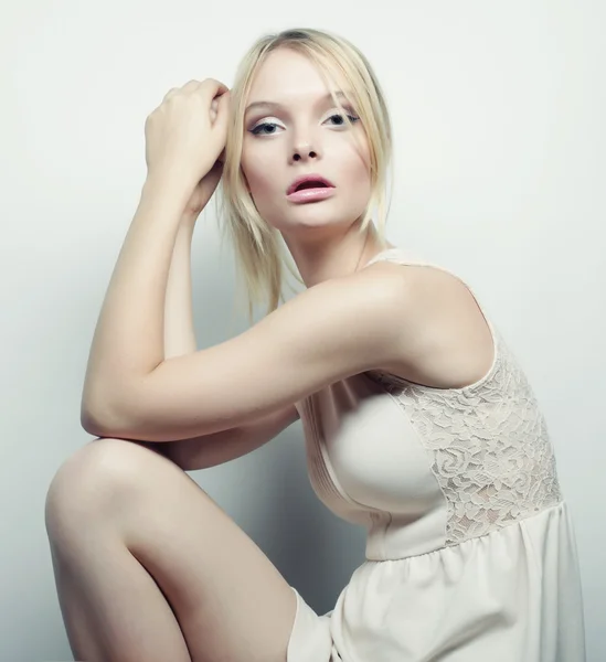 Blonde model sitting on a stool — Stock Photo, Image