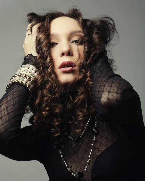 Young fashion model with curly hair — Stock Photo, Image