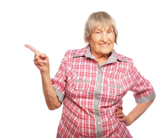 Happy senior woman pointing upwards — Stock Photo, Image