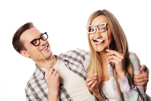 Lovely couple holding party glasses on stick — Stock Photo, Image