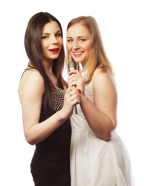 Two sensual girls singing with microphone — Stock Photo, Image