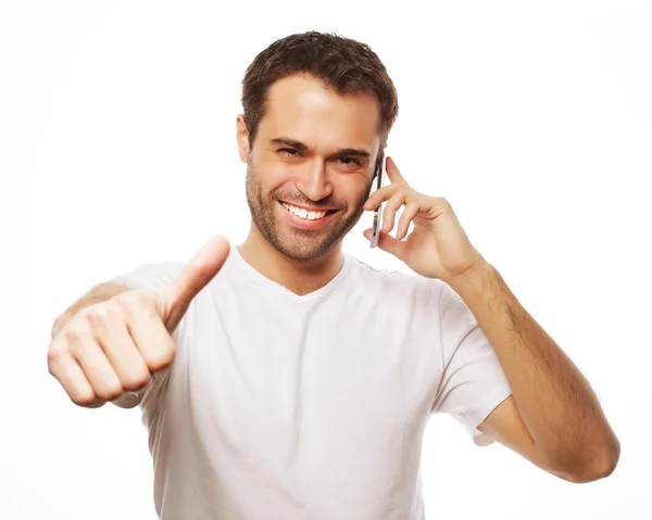Casual young man showing thumbs up sign — Stock Photo, Image