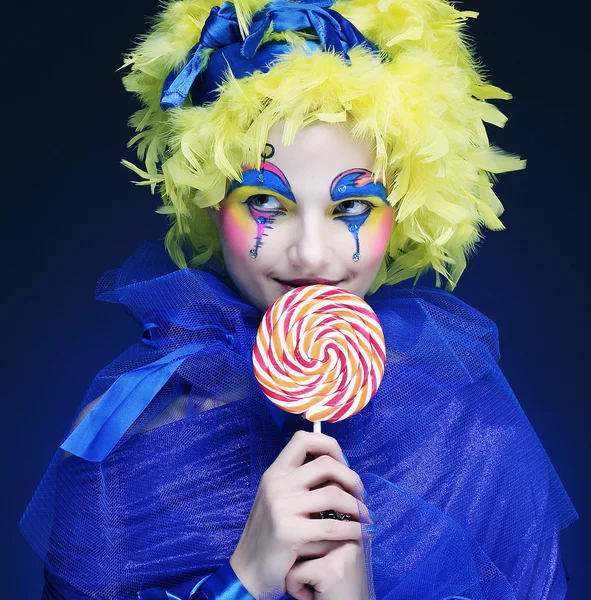 Girl with with creative make-up holds lollipop — Stock Photo, Image