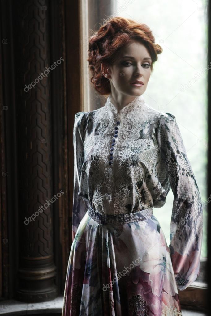  woman in pink dress posing in luxury palace