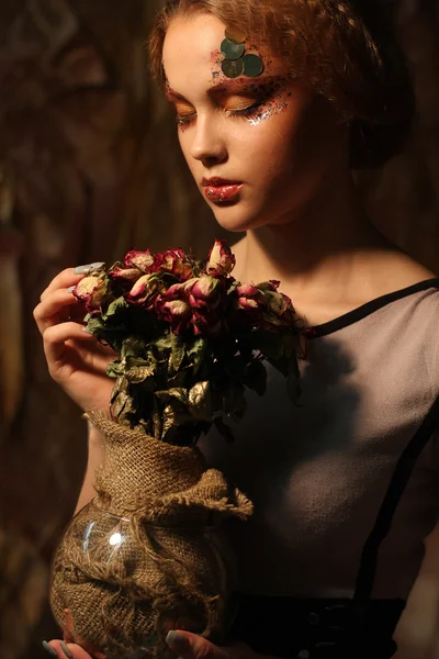 Beautiful girl with dry roses — Stock Photo, Image