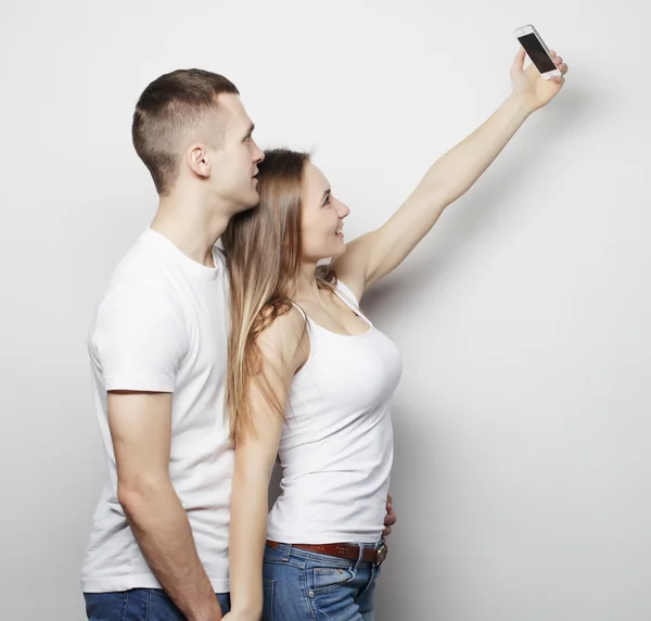 Smiling couple with smartphone, selfie and fun. — Stock Photo, Image