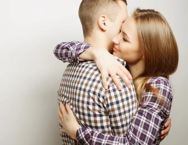Lovely happy couple hugging over grey background. — Stock Photo, Image