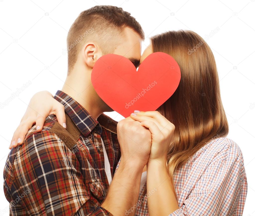 Happy couple in love holding red heart.