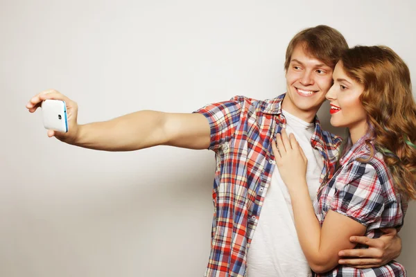 Smiling couple with smartphone, selfie and fun. — Stock Photo, Image