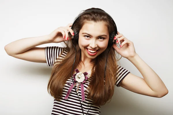 Jeune femme heureuse avec écouteurs écouter de la musique — Photo