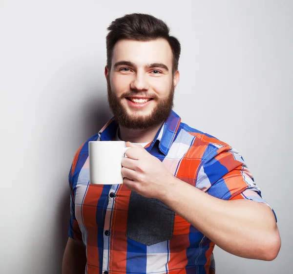 Young bearded man with a cup of coffee — Stock Photo, Image