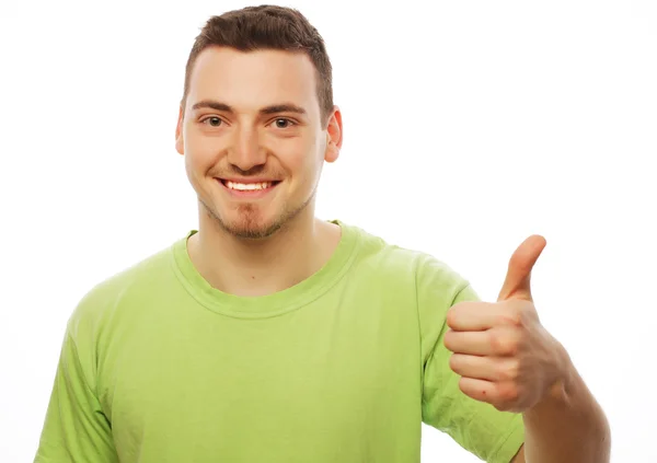Young man in green shirt  showing thumbs up. — Stock Photo, Image