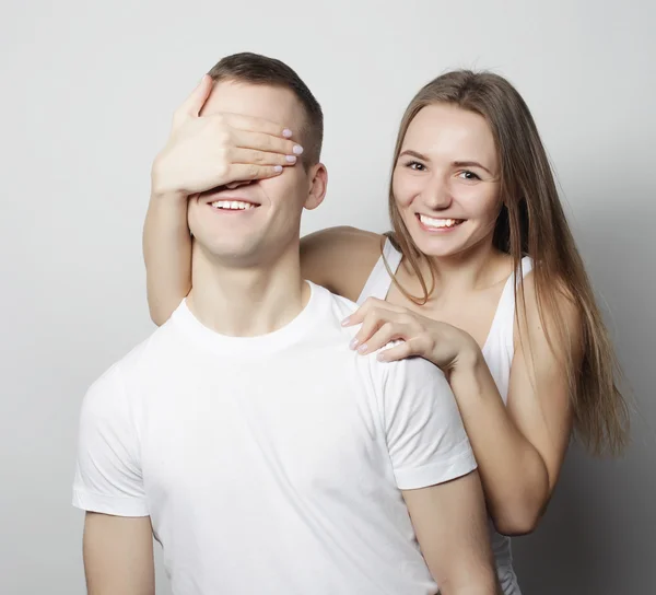 Young woman closing his boyfriend eyes. — Stock Photo, Image