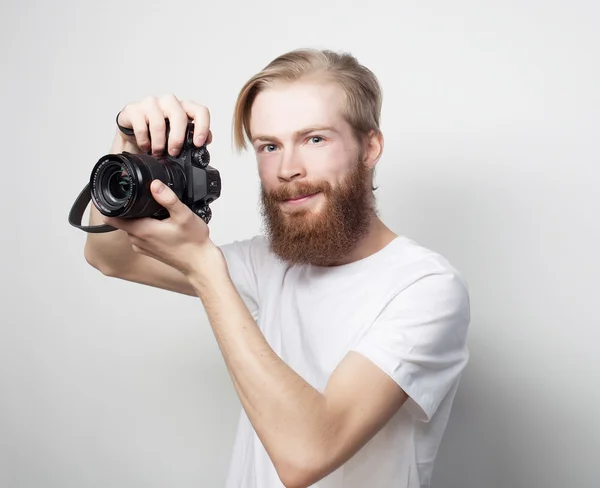 Bearded man with a digital camera — Stock Photo, Image