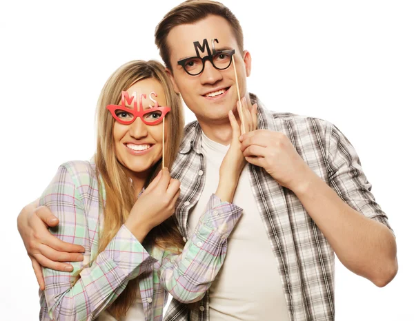 Lovely couple holding party glasses on stick — Stock Photo, Image