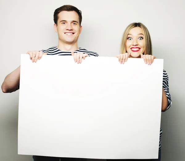 Couple holding a banner - isolated over a white background — Stock Photo, Image