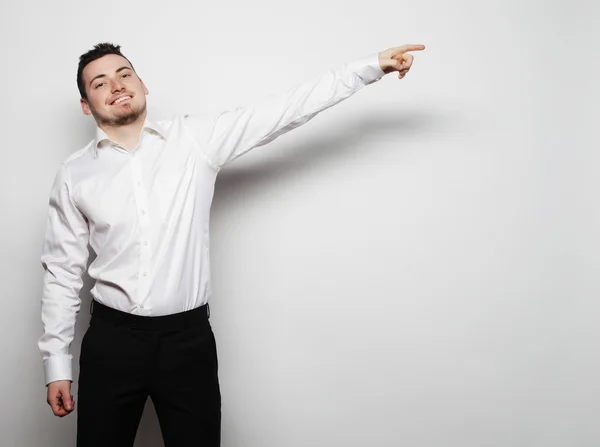 Business man points with fingers in the right side — Stock Photo, Image