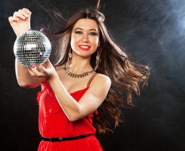 Disko topu tutmak Kırmızı elbiseli genç kadın