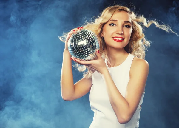 Beautiful young woman holding disco ball at night club — Stock Photo, Image