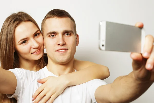 Sorrindo casal com smartphone, selfie e diversão . — Fotografia de Stock