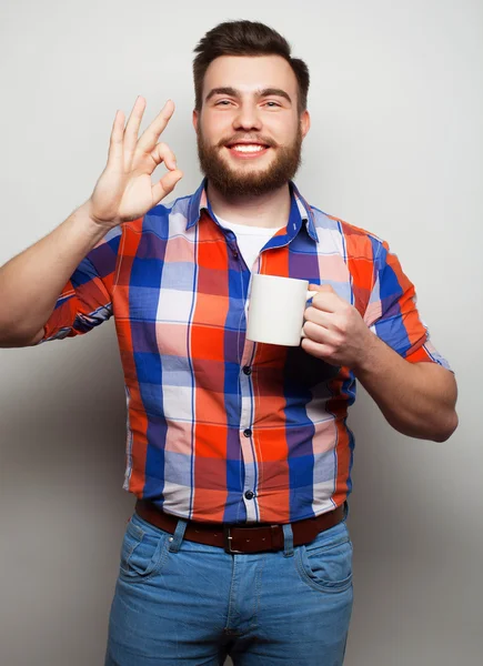 Young bearded man with a cup of coffee — Stock Photo, Image