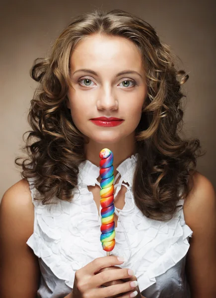 Mujer joven con piruleta de colores — Foto de Stock