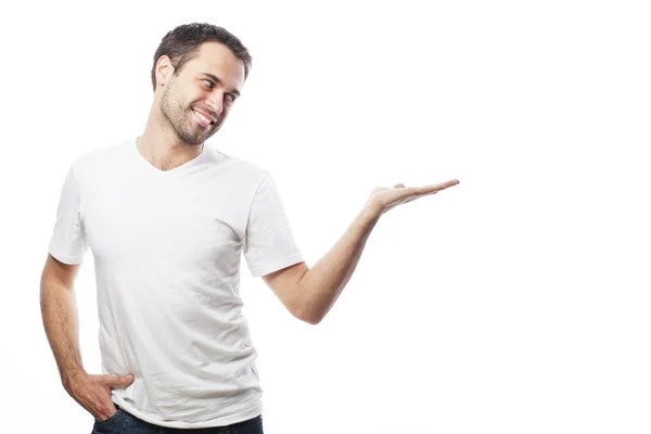 Young smiling happy man shows something — Stock Photo, Image