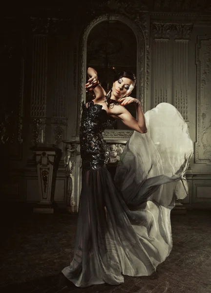 宮殿の部屋で空飛ぶドレスを着た優雅な女性 — ストック写真