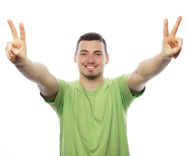 Young casual man showing the victory gesture — Stock Photo, Image