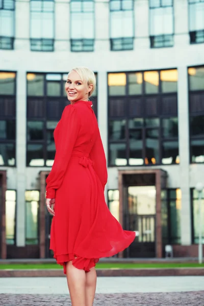 Happy beautiful woman in red summer dress — Stock Photo, Image