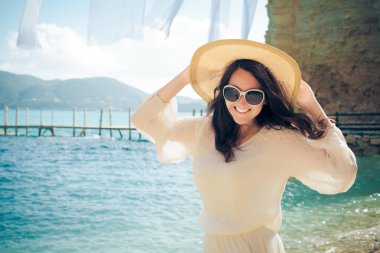 Sahilde şapkalı mutlu kadın