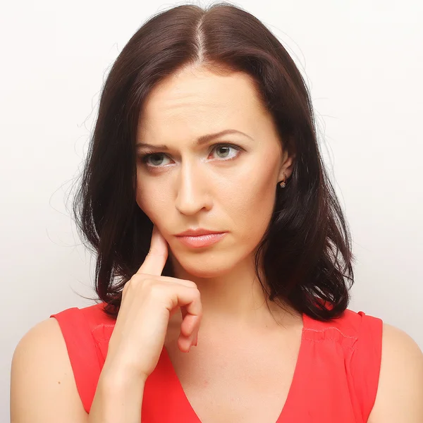 Thinking woman. Studio shot. — Stock Photo, Image