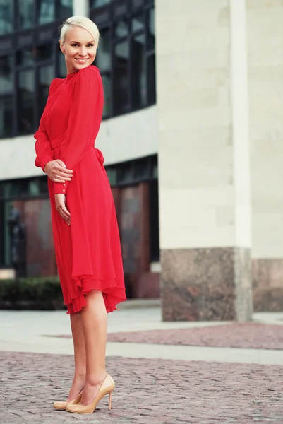 Happy beautiful woman in red summer dress — Stock Photo, Image