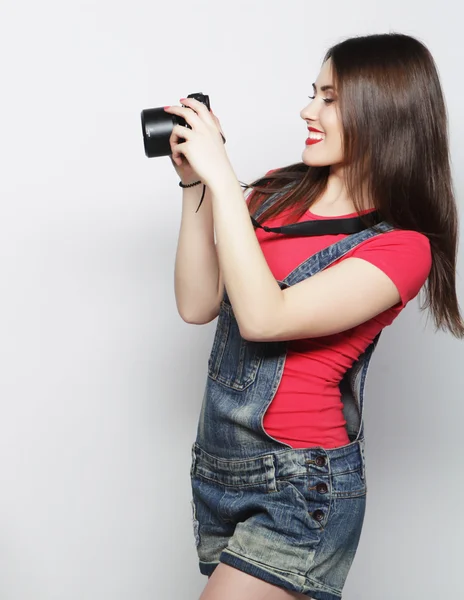 Beautiful young woman with camera — Stock Photo, Image