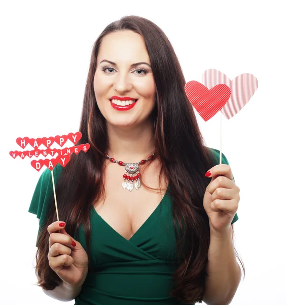 Beautiful woman wearing green dress holding paper hearts — Stock Photo, Image