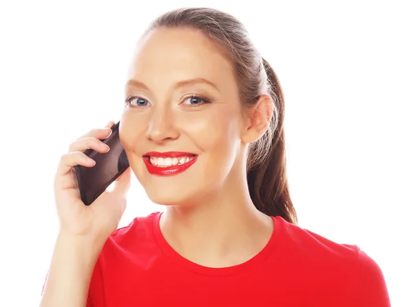 Woman using a mobile phone isolated on a white background — Stock Photo, Image