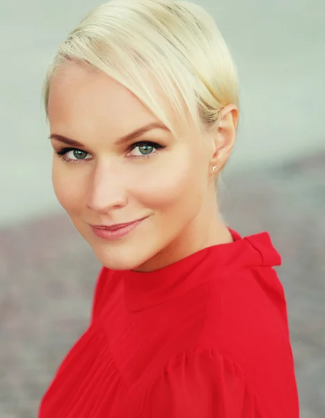 Happy young blond woman, wearing red dress — Stock Photo, Image