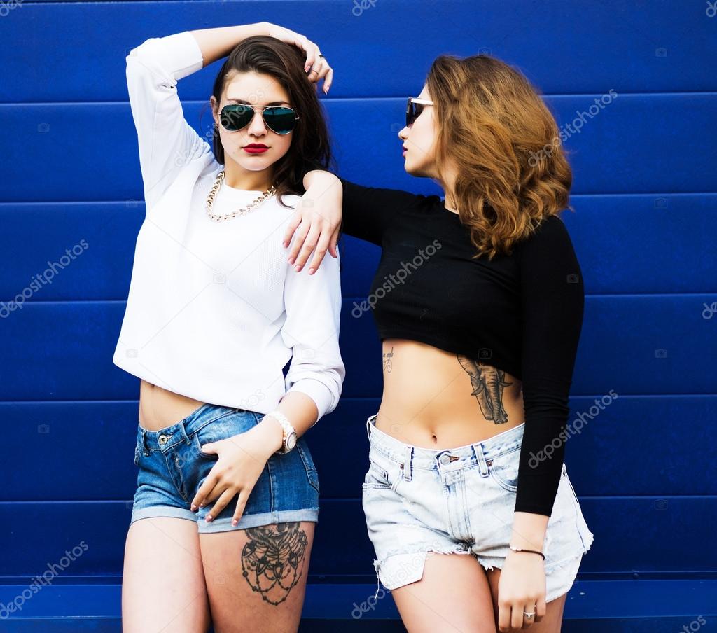 Two young girlfriends in sunglasses having fun.