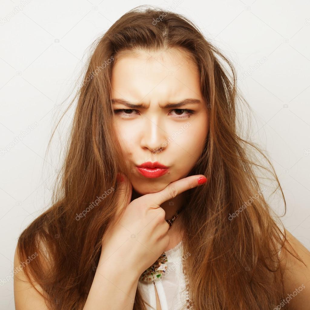 Portrait of a beautiful young woman thinking