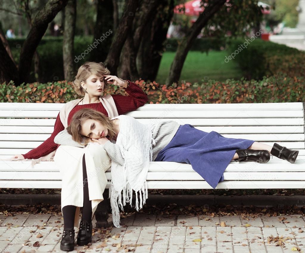 young women sitting on a bench