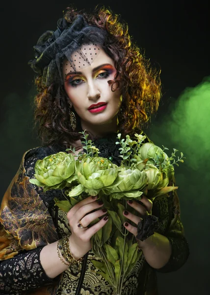 Woman with brigt visage holding big green flowers — Stock Photo, Image