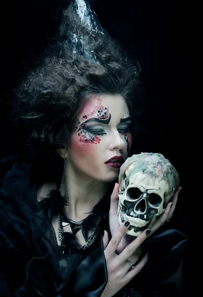 Picture a beautiful fantasy woman with skull. Halloween theme. — Stock Photo, Image