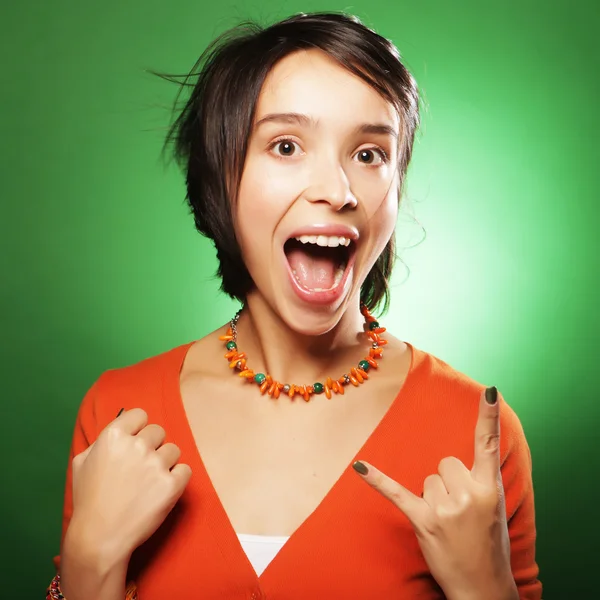 Young expression woman over green background — Stock Photo, Image