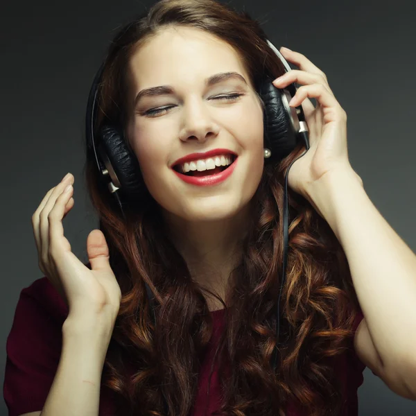 Молода жінка з навушниками слухати музику — стокове фото