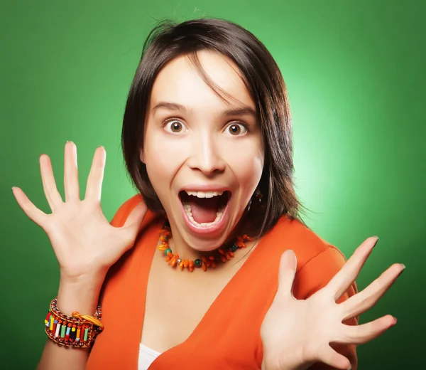 Young expression woman over green background — Stock Photo, Image