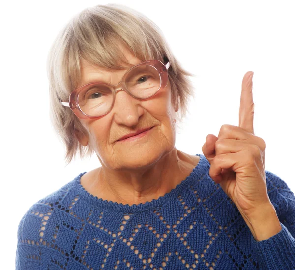 Mujer mayor feliz apuntando hacia arriba —  Fotos de Stock