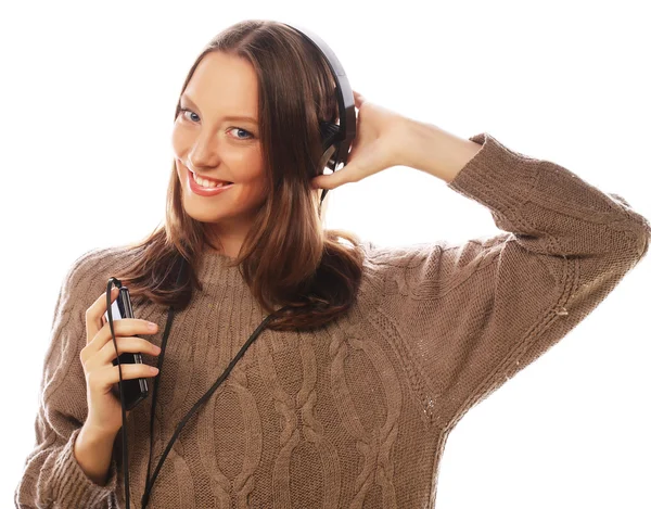 Młoda szczęśliwa kobieta ze słuchawkami słuchająca muzyki — Zdjęcie stockowe