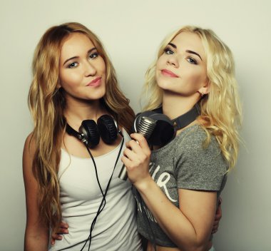 Beauty girls with a microphone singing and dancing