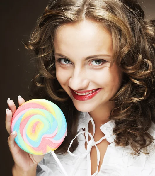 Curly  girl with a lollipop in her hand — Stock Photo, Image